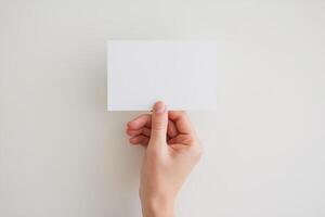 A person holding up a blank piece of paper photo
