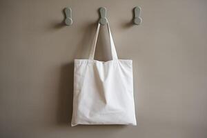 A Simple White Tote Bag Hanging on Modern Hooks photo