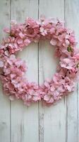 Elegant studio shot of pink sakura petals wreath on rustic wooden background for spring decor photo