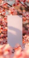 Elegant white greeting card among pink blossoms for spring celebrations and invitations photo