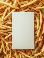 Blank white menu card surrounded by golden french fries for restaurant branding design photo