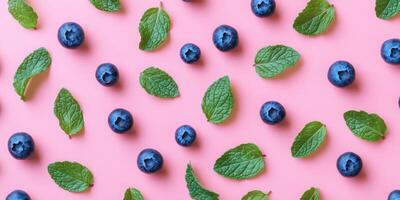 Ultra realistic minimalistic flat lay of blueberries and mint leaves on pink background for creative design photo