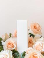 Elegant floral arrangement with white roses and minimalist blank card for romantic celebrations and invitations photo