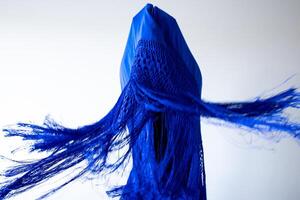Abstract blue fabric art with dynamic fringes and geometric shapes photo