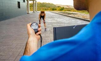 A man holding a remote control while a woman is running photo