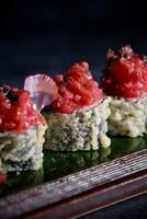 Sushi rolls with red sauce on a green plate photo