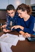 A man and woman looking at paperwork on a table photo