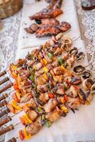A table with a bunch of skewers on it. photo