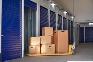 A storage unit with boxes and a cart photo