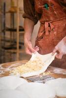 A man is making dough on a table photo