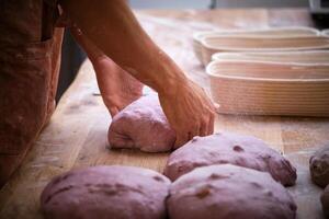 A chef is kneading dough on a table. photo