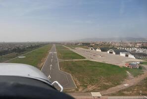 A view of a runway from an airplane. photo