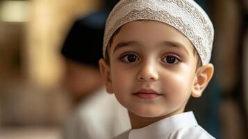 A close-up portrait of a boy in traditional attire, exuding innocence. photo
