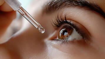 Close-up of a dropper applying liquid to an eye for skincare. photo