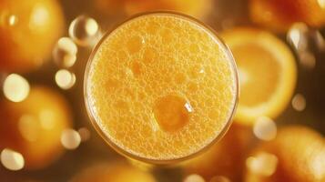 A refreshing glass of orange juice surrounded by citrus fruits. photo