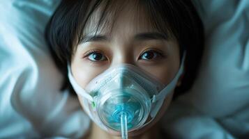 Close-up of a patient with an oxygen mask in a hospital setting. photo