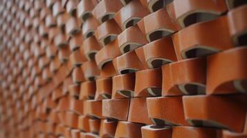 A textured, warm toned wall of stacked clay bricks showcasing craftsmanship. photo