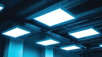 Modern ceiling lights create a luminous and atmospheric blue glow. photo