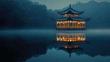 A serene pavilion reflected on misty waters at dusk. photo