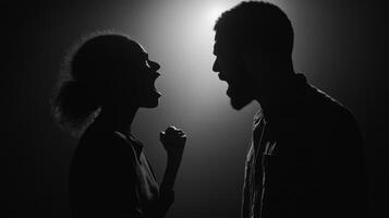 Dramatic silhouettes of a couple in a fierce argument. photo