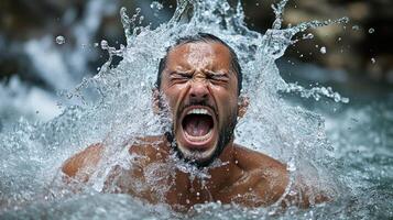 A man joyfully screaming as water splashes around him. photo