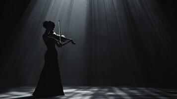 A silhouette of a violinist performing under dramatic lighting. photo