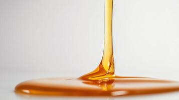 Close up of golden syrup dripping in a smooth, glossy flow. photo