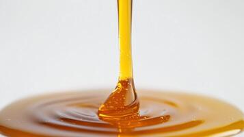 Golden syrup flows smoothly, creating a glossy texture. photo