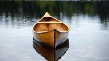 A serene wooden canoe reflecting on calm water in a tranquil setting. photo