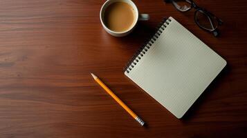 notebook, pencil, and coffee cup on wooden table photo
