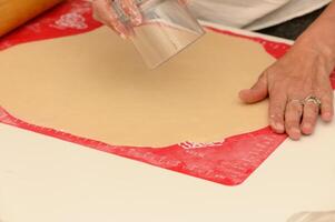 Rolling out dough and preparing pastries in a sunny kitchen for a delicious baking session photo