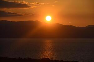 Breathtaking sunset over tranquil lake reflecting golden hues of twilight photo