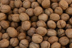 Gathering fresh walnuts in a rustic market during autumn harvest season photo