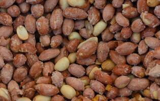 Natural blend of roasted peanuts showcasing various shades and textures in a vibrant arrangement photo