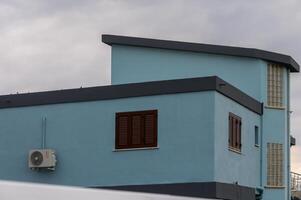 Modern blue building against cloudy sky with an urban feel and contemporary design in the neighborhood photo