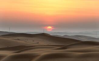 The sun sets over the desert in the middle of the day photo