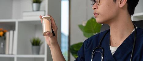 Medication Management and Student Understanding. A medical student studying medication concepts with a prescription bottle in hand. photo