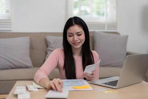 Progressing towards Financial Stability. A young woman smiling while organizing her finances, emphasizing the journey of budgeting and financial empowerment. photo