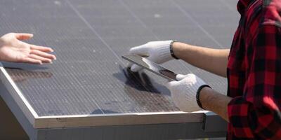 Installation and Maintenance of Solar Panels. A focused technician examines solar panel surfaces while demonstrating knowledge in renewable energy. photo