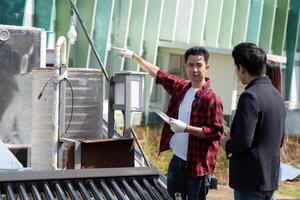 Sustainable Energy Solutions and Consultation. A technician explaining eco-friendly technologies during a site visit. photo
