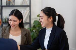 Collaboration and Business Strategy. Two professional women engaging in a discussion over a project in a modern office environment. photo