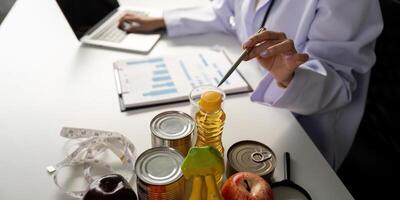 Health and Nutrition Evaluation. A healthcare expert analyzing food items and health charts while utilizing technology for dietary advice. photo