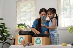 Recycling and Childhood Learning. A mother and daughter explore recycling practices, creating memories while sorting waste. photo
