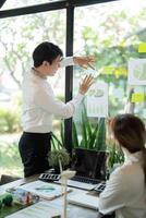 Presentation and Engagement. A professional presenting sustainable development ideas with visuals. photo