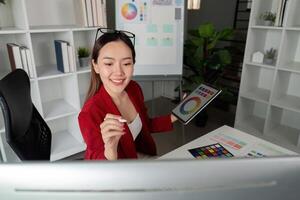 Virtual Workspace and Collaborative Design. A graphic designer interacting with digital art on a computer. photo