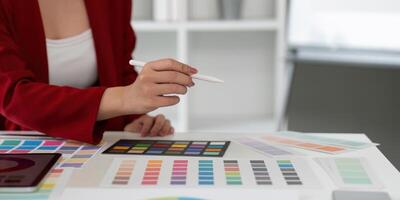Color Theory and Graphic Design. A graphic designer focuses on a range of color swatches. photo