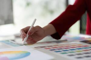 Digital Illustration and Color Selection. A graphic designer enhances artwork using a stylus. photo