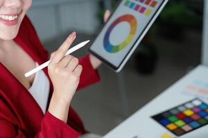 Creative Design and Digital Art. A graphic designer discusses color palettes on a tablet. photo