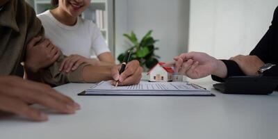 Real Estate and Partnership. A couple engaging with their real estate agent to finalize a home purchase. photo