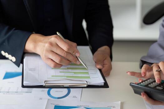 Collaboration and Data Analysis. Colleagues discussing performance metrics during a meeting. photo